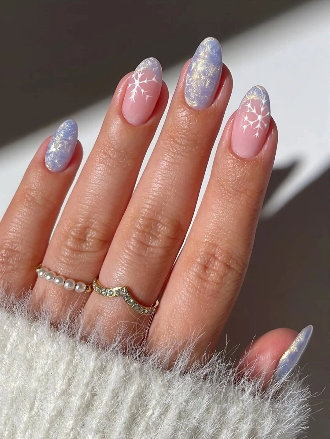 Almond nails with lavender shimmer and white snowflakes